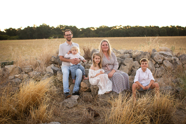 Danielle (founder of Liberty and Whimsy Boutique) Sitting with her husband and three kids