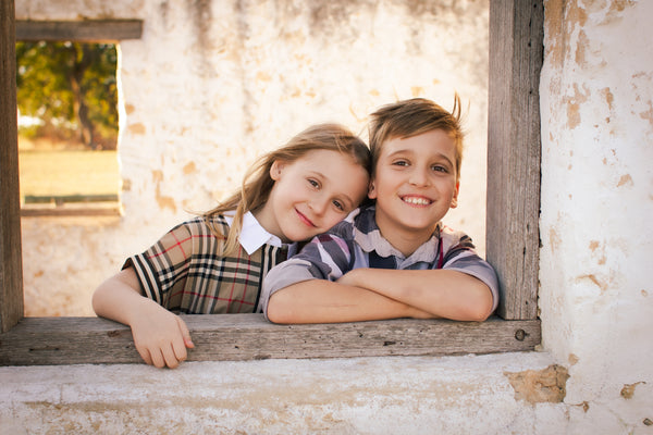 A young boy and girl wearing clothing supplied by Liberty and Whimsy Boutique
