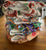 Bundle of 15 modern cloth nappies with inserts: Designer Bums, Junior Tribe Co, Fudgey Originals, Yoho & Co, Sassy Pants and Fluffy Ducks