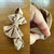 Tan Sz L bow 21.5cm 1-3y NWOT