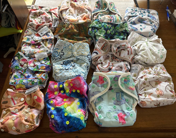 Bundle of 15 modern cloth nappies with inserts: Designer Bums, Junior Tribe Co, Fudgey Originals, Yoho & Co, Sassy Pants and Fluffy Ducks